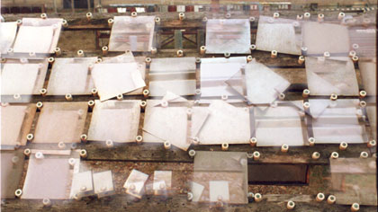 Exposure, still: Slippage: This tracking sequence was constructed at the site on my Nikon stills camera using a number of 36exp. 35mm rolls. These rolls of film were hand-processed at different temperatures, dilutions and timings – giving a varied mix of under/over exposure and high/low contrast &amp; saturation levels. The results were scanned, mixed and printed up for shooting on my rostrum.