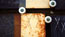 Exposure, still 11: XXX a: This and the next two images are from an evolving sequence toward the end of the film. A number of a particular type of plate have been merged into each other using simple dissolves – but in ‘framed’ areas of the image. These images all contain the strong feature of (actual) overlaid _scratched crosses_. Theses are used at the site to kick-start the processes of deterioration, but for me they suggest small signatures – little identity stamps.